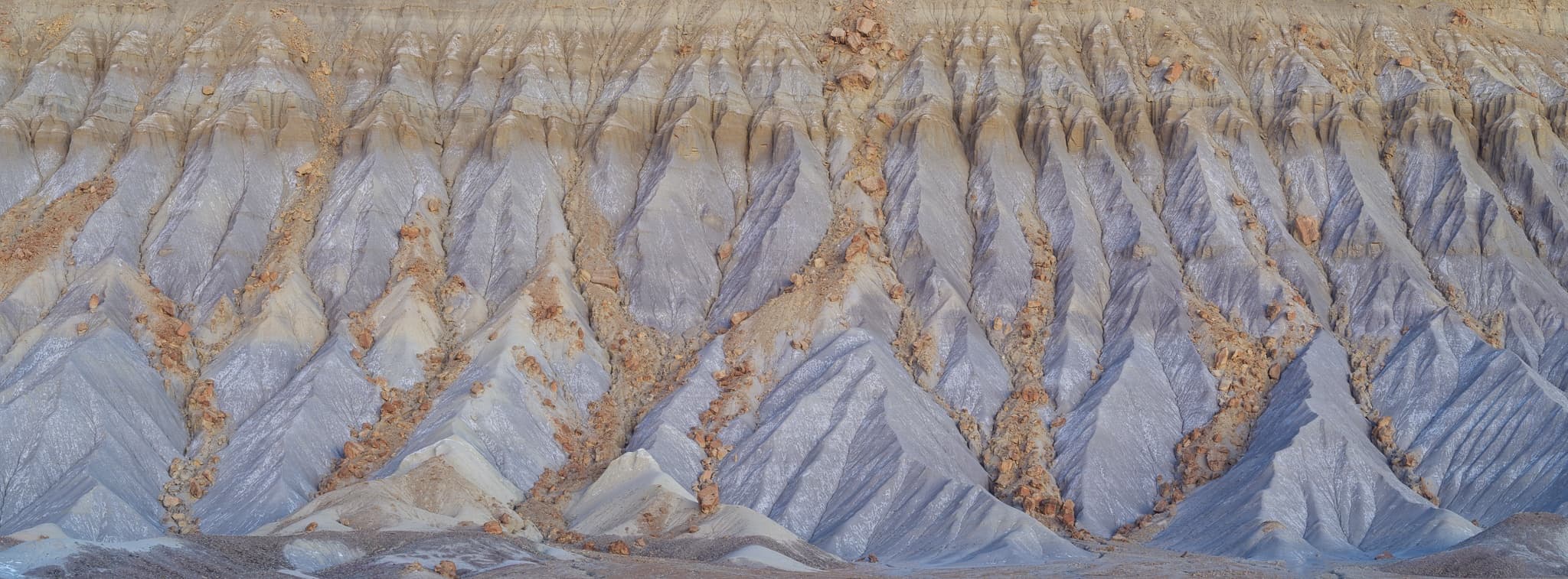 Close-up detail of Caineville Mesa in Utah's Capitol Reef country — the eroded badlands surface in panoramic format, shot on the Fujifilm GFX100S in fall. Photograph by Marty Quinn